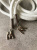 Шнурок белый, наконечник металл цвет серебро (подвеска буква М), длина 135 см ШКБ/135/6549 по цене 265 руб./штука